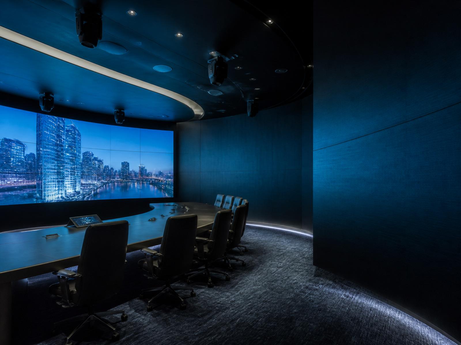 Professional AV boardroom with curved LED video wall and integrated control systems
